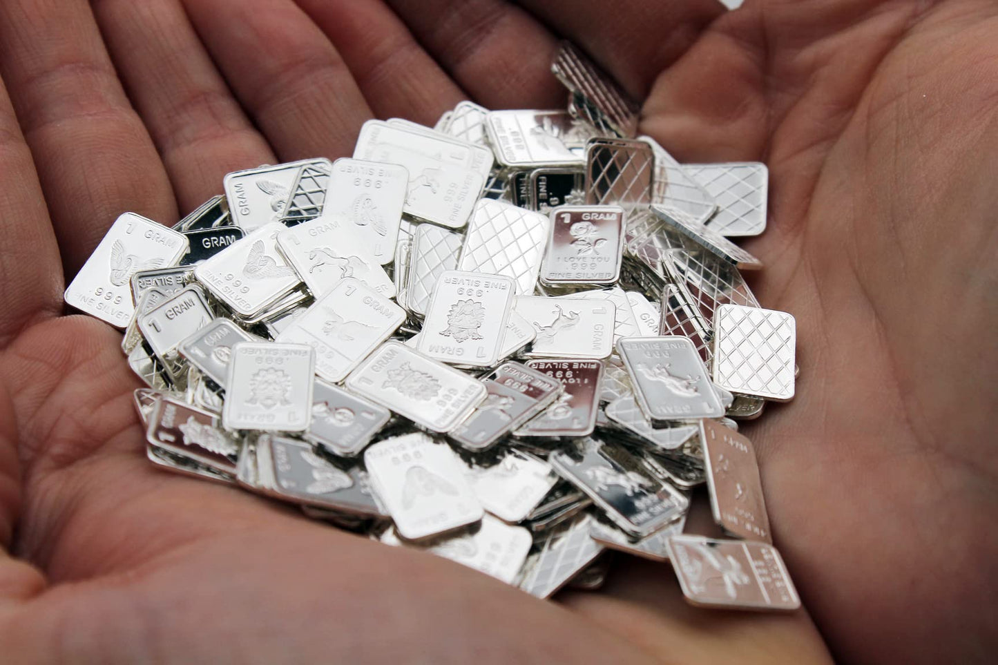 Ten (10) One Gram .999 Pure Silver Bars with Random Designs in a Jewelry Pouch by Mint State Gold